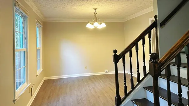 a view of an entryway with wooden floor and stairs