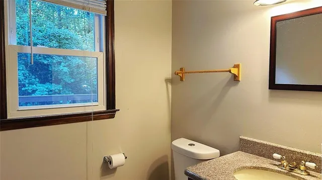 a white toilet sitting next to a bathroom sink