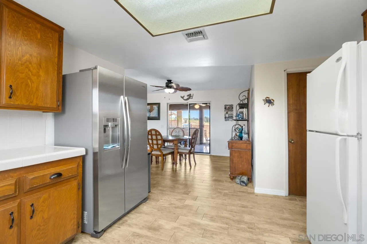 31478 Valley Center Road Valley Center, CA 92082 - Photo 30 of 66 a view of a kitchen with a refrigerator and a stove