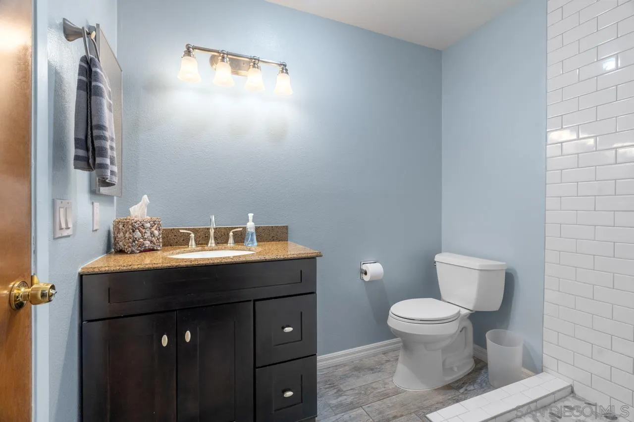 31478 Valley Center Road Valley Center, CA 92082 - Photo 32 of 66 a bathroom with a toilet sink and mirror