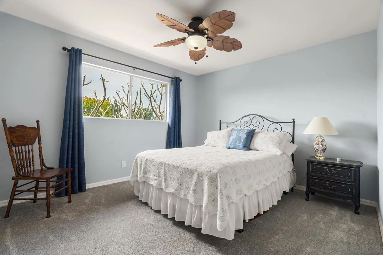 31478 Valley Center Road Valley Center, CA 92082 - Photo 34 of 66 a bedroom with a bed and a chandelier