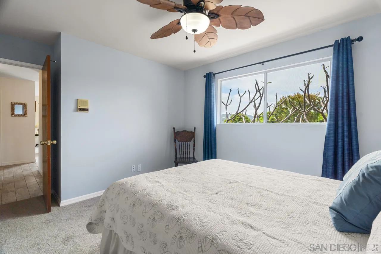 31478 Valley Center Road Valley Center, CA 92082 - Photo 35 of 66 a bedroom with a bed and a chandelier