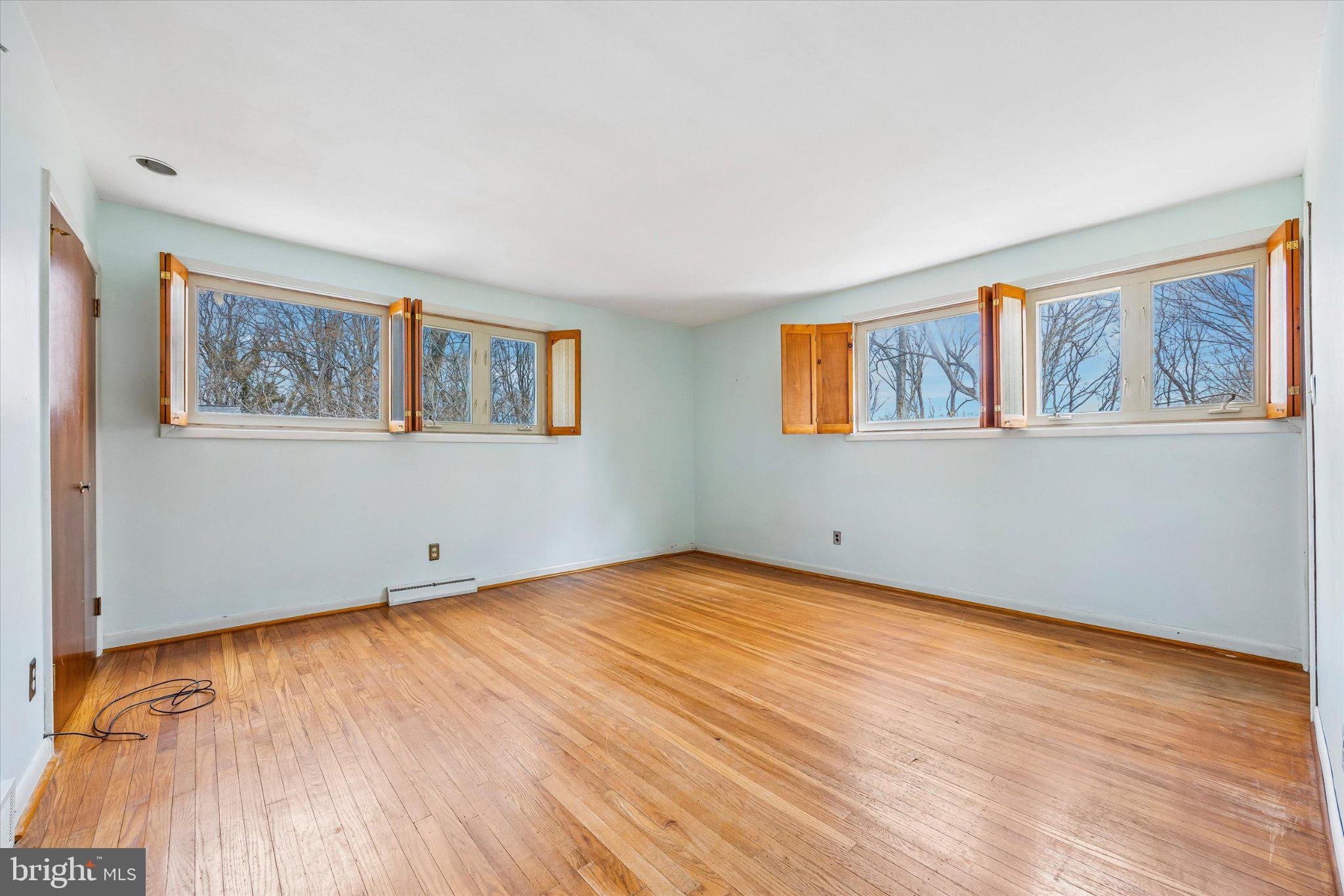 675 Trephanny Lane Wayne, PA 19087 - Photo 11 of 36 a view of an empty room with window and wooden floor