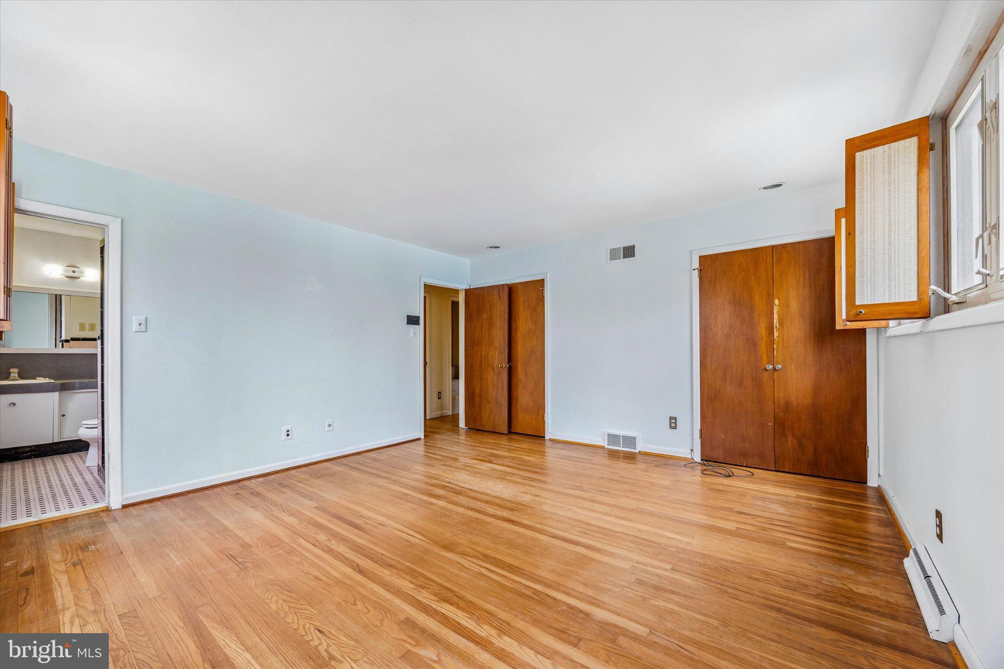 675 Trephanny Lane Wayne, PA 19087 - Photo 12 of 36 a view of an empty room with wooden floor and a window