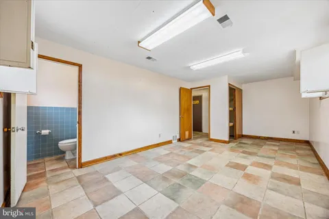 a view of an empty room and a bathroom
