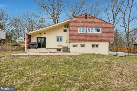 a view of a house with a yard covered in snow