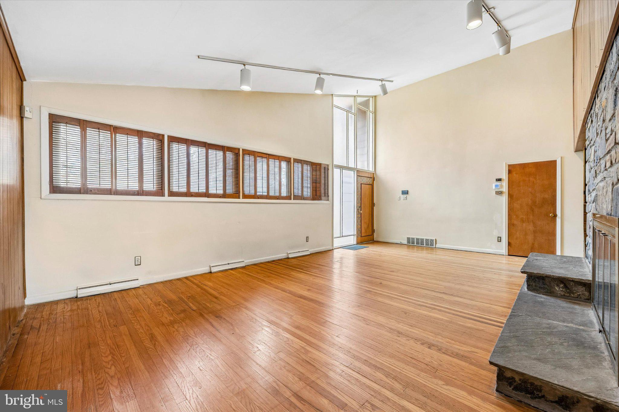 675 Trephanny Lane Wayne, PA 19087 - Photo 4 of 36 a view of an empty room with wooden floor and a window