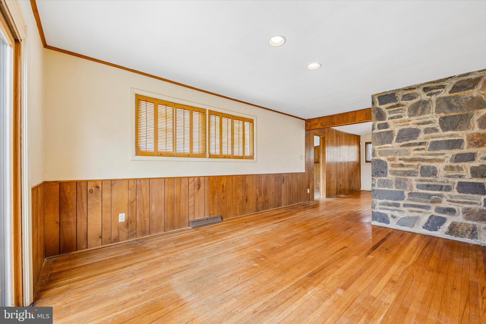 675 Trephanny Lane Wayne, PA 19087 - Photo 5 of 36 a view of an empty room with wooden floor and a window