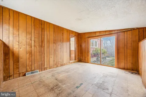 a view of an empty room with wooden walls