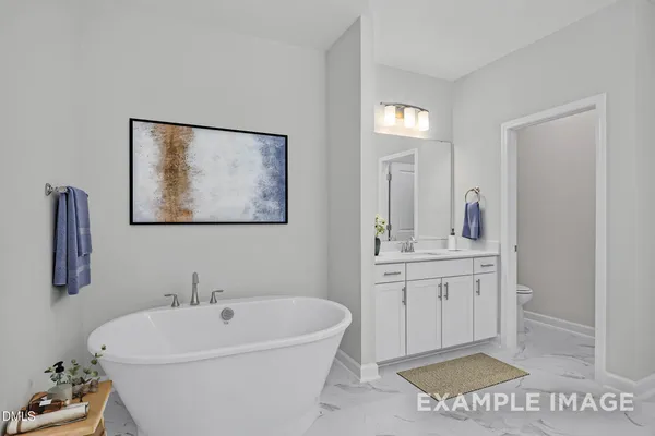a spacious bathroom with a tub sink and mirror