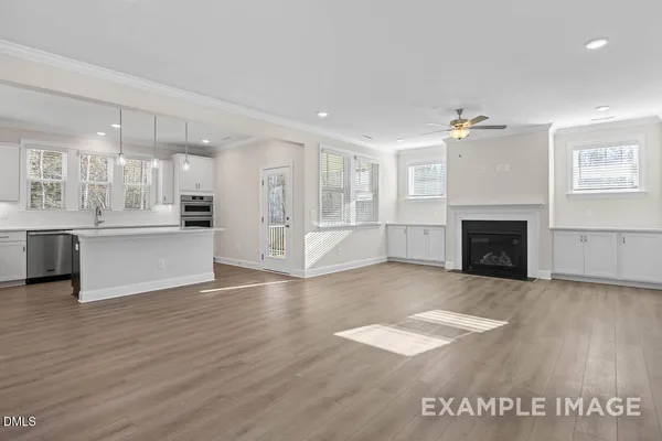 a view of a kitchen with wooden floor and a kitchen
