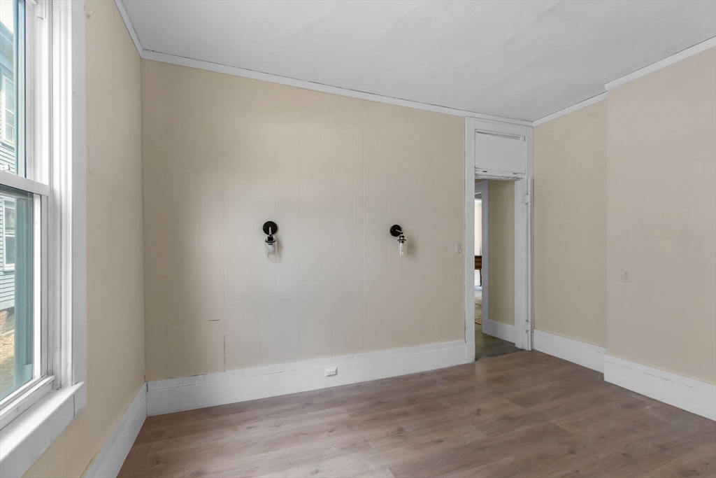 102 Florida Street Springfield, MA 01109 - Photo 13 of 45 an empty room with wooden floor and windows
