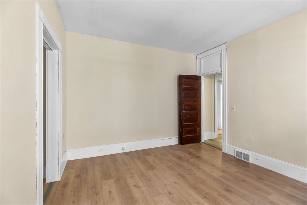 102 Florida Street Springfield, MA 01109 - Photo 18 of 45 a view of an empty room with wooden floor