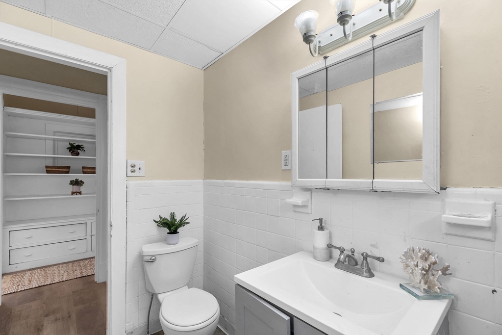 102 Florida Street Springfield, MA 01109 - Photo 20 of 45 a bathroom with a sink a toilet and vanity