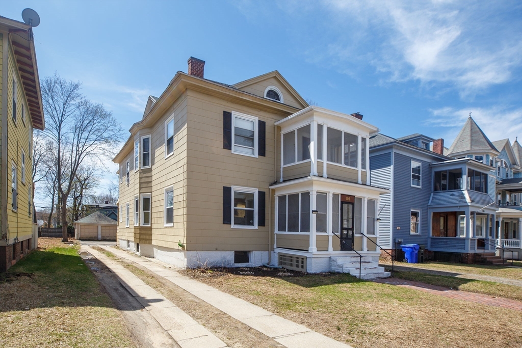 102 Florida Street Springfield, MA 01109 - Photo 2 of 45 a front view of a building with a yard