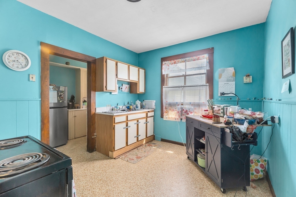 102 Florida Street Springfield, MA 01109 - Photo 21 of 45 a kitchen with a stove and a refrigerator
