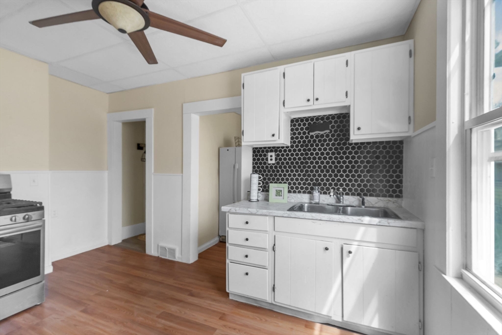 102 Florida Street Springfield, MA 01109 - Photo 3 of 45 a kitchen with a sink cabinets and window