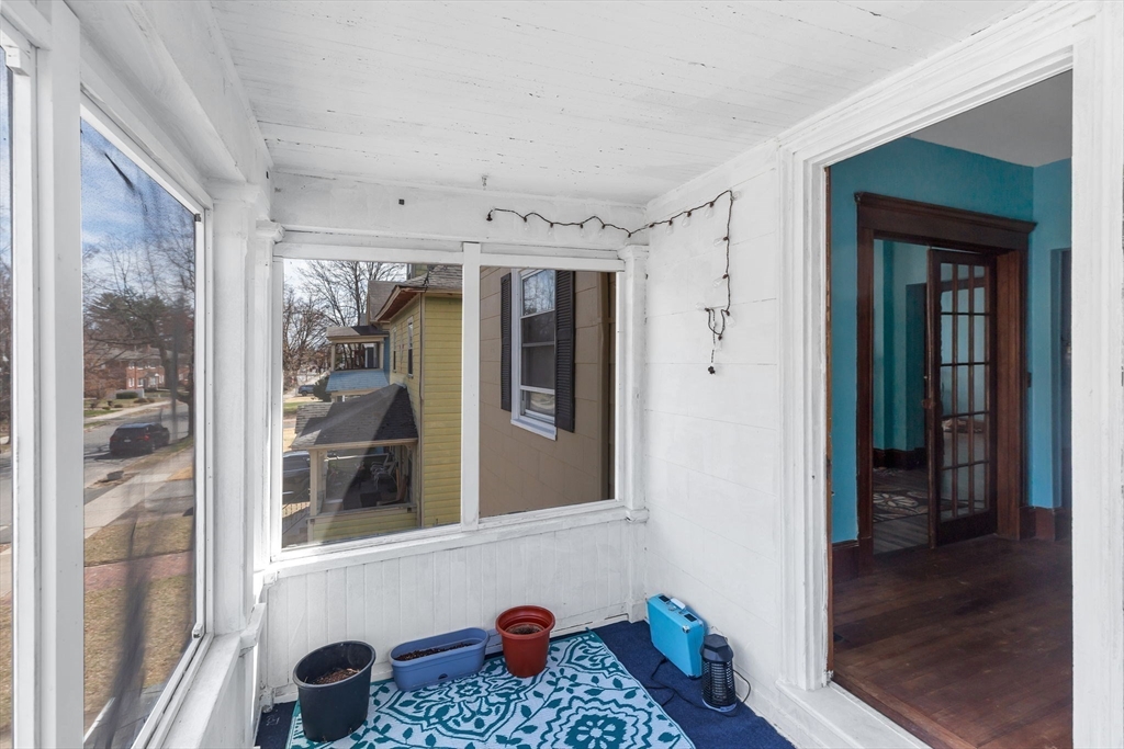 102 Florida Street Springfield, MA 01109 - Photo 31 of 45 a hallway with front door wooden floor and windows