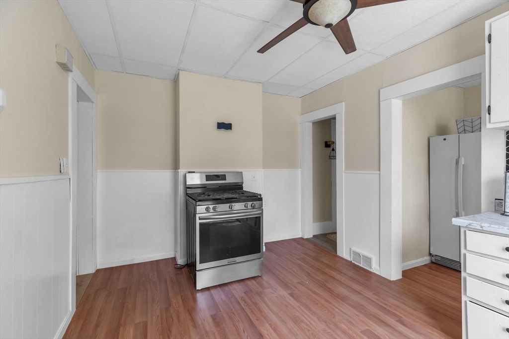 102 Florida Street Springfield, MA 01109 - Photo 4 of 45 a view of a kitchen with wooden floor electronic appliances and wooden floor