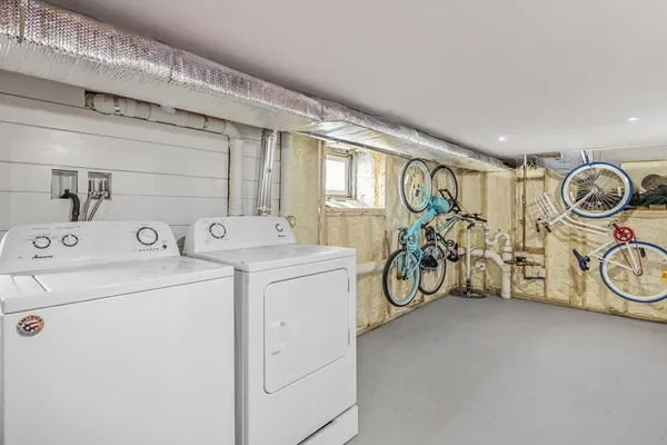 a view of storage and utility room with washer and dryer