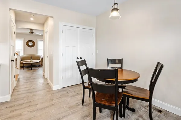 a dining room with furniture and window