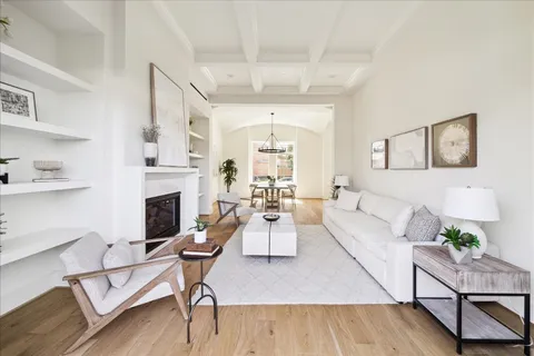 a living room with furniture fireplace and window