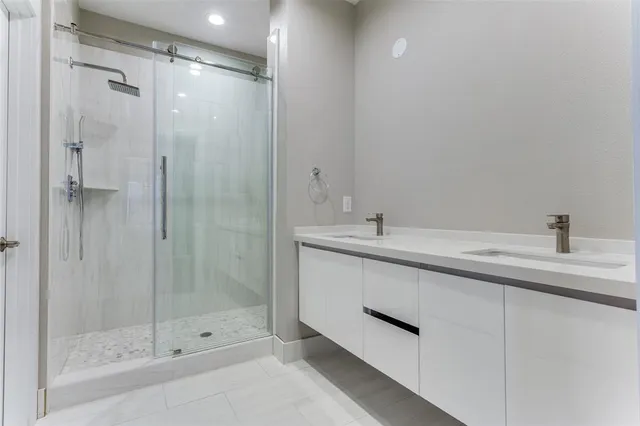 a bathroom with a shower sink and mirror