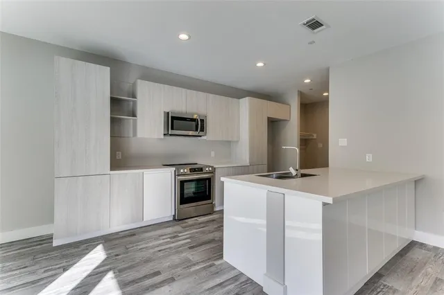 a kitchen with cabinets and a stove