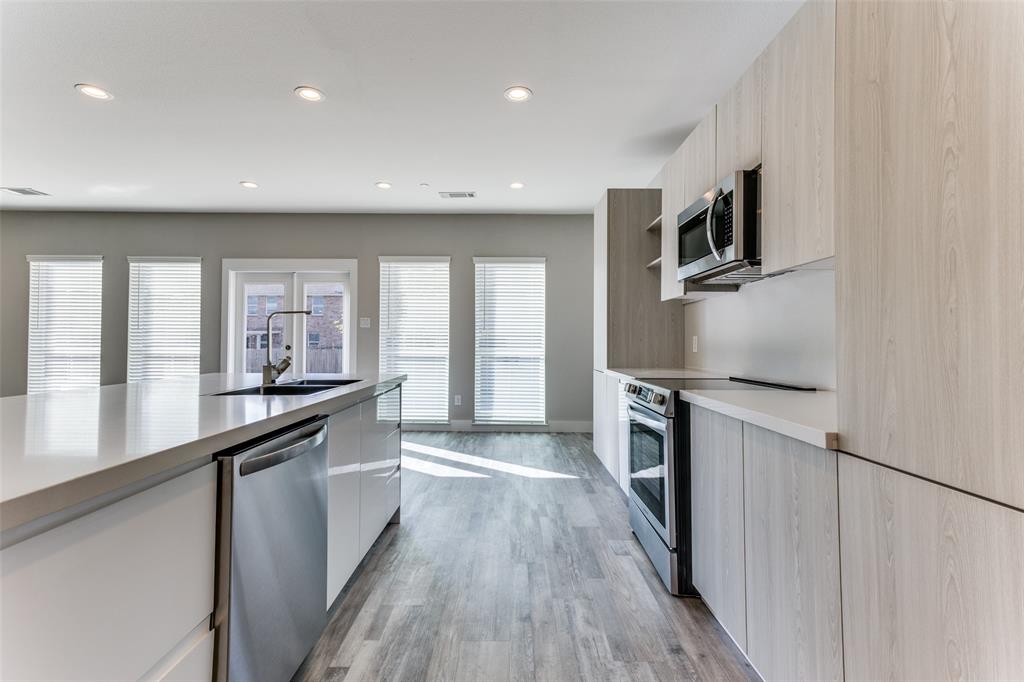 3021 Mayeda Circle Wylie, TX 75098 - Photo 5 of 13 a kitchen with stainless steel appliances a sink stove and refrigerator