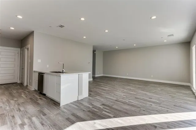 an empty room with wooden floor