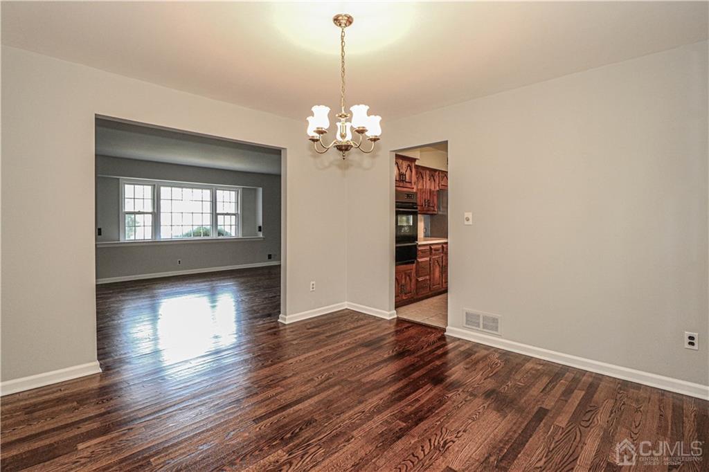320 Plainfield Road Edison, NJ 08820 - Photo 12 of 50 a view of an empty room with window and wooden floor