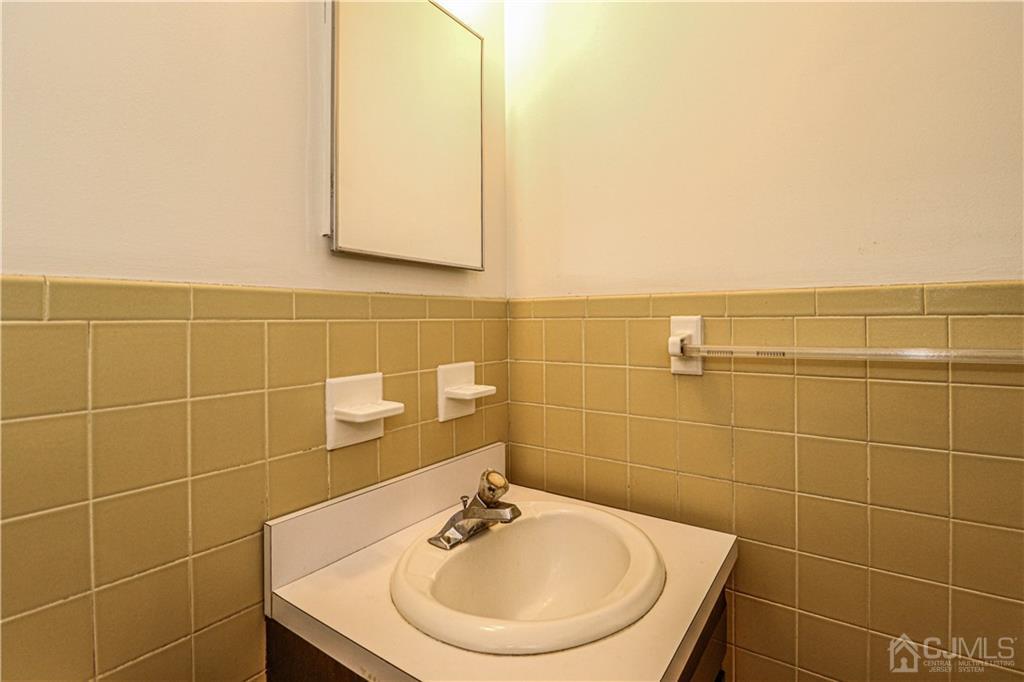 320 Plainfield Road Edison, NJ 08820 - Photo 23 of 50 a bathroom with a sink a mirror and a shower