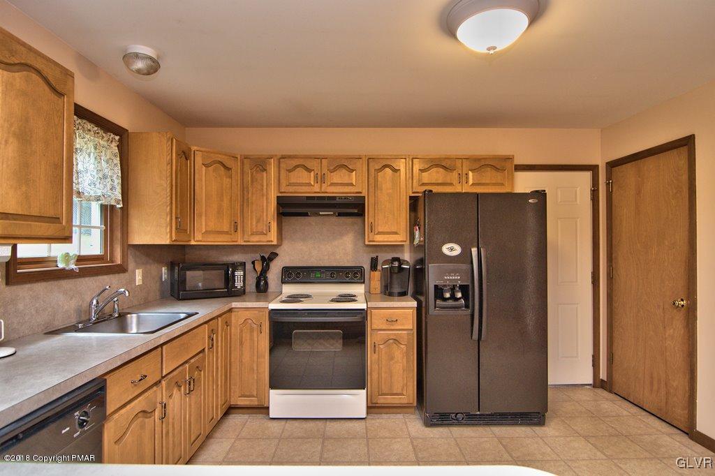 251 Devils Hole Road Cresco, PA 18326 - Photo 12 of 35 a kitchen with stainless steel appliances granite countertop a refrigerator a sink dishwasher and a stove