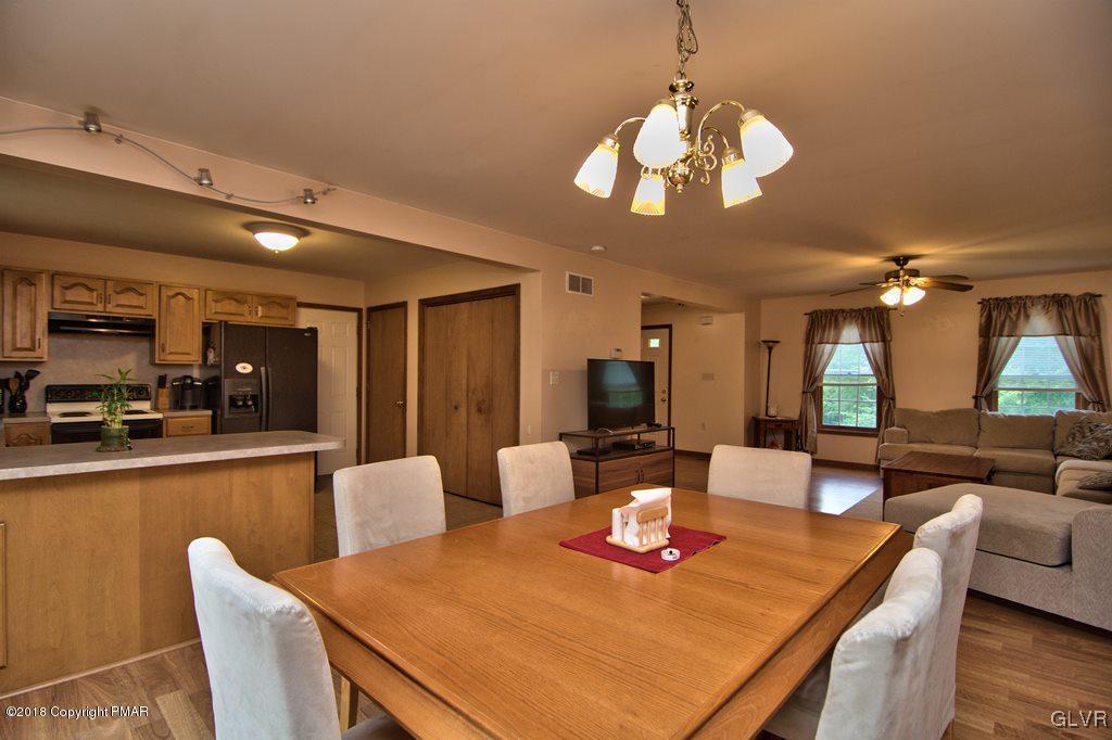 251 Devils Hole Road Cresco, PA 18326 - Photo 16 of 35 a view of a dining room with furniture a chandelier and wooden floor