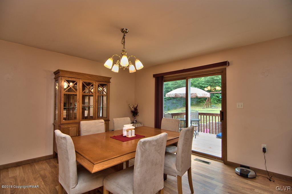 251 Devils Hole Road Cresco, PA 18326 - Photo 18 of 35 a view of a dining room with furniture wooden floor and chandelier