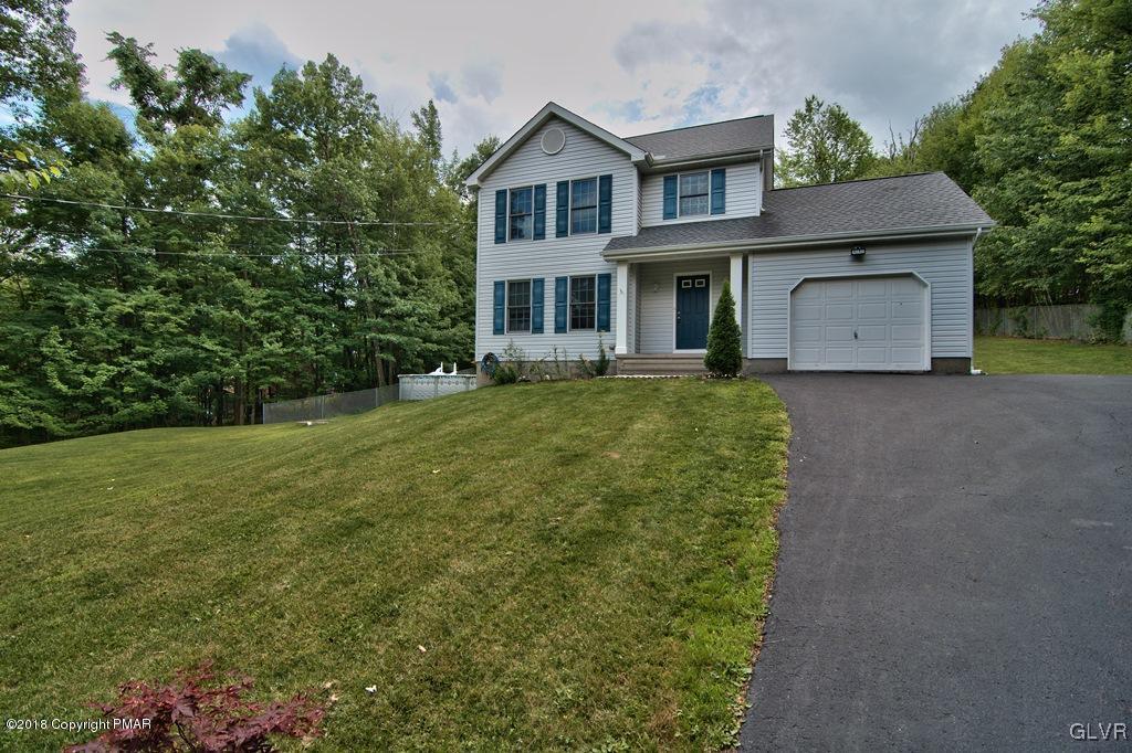 251 Devils Hole Road Cresco, PA 18326 - Photo 2 of 35 a front view of a house with a yard and garage
