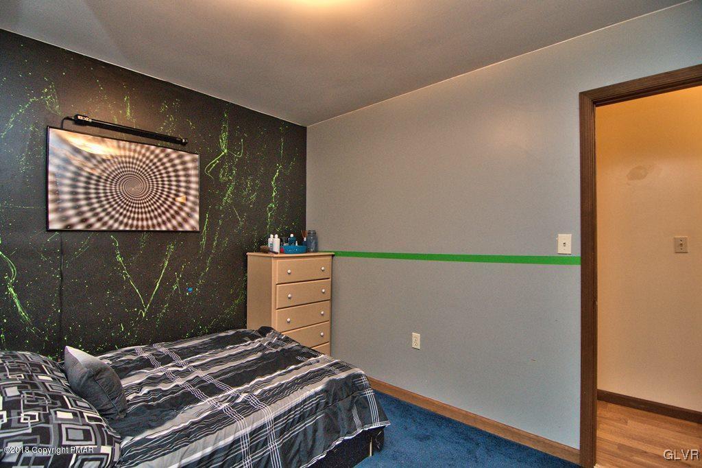 251 Devils Hole Road Cresco, PA 18326 - Photo 25 of 35 a bedroom with a bed and cabinets