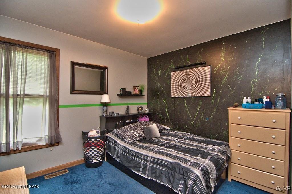 251 Devils Hole Road Cresco, PA 18326 - Photo 26 of 35 a bedroom with a bed and a dresser