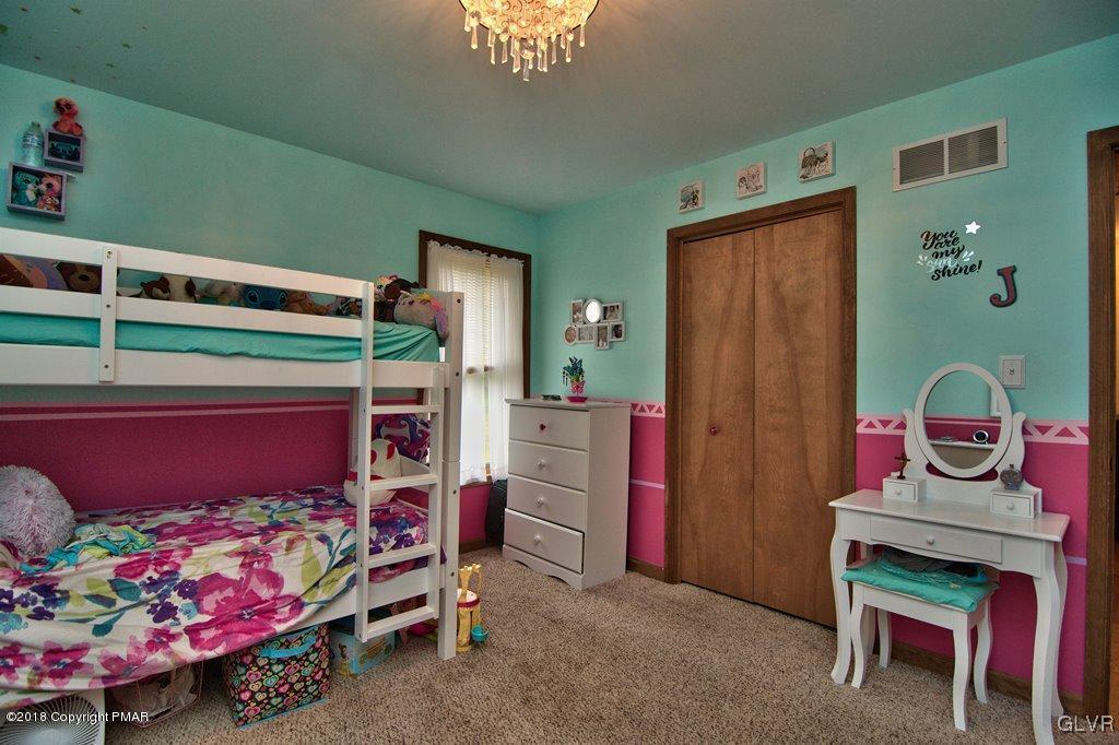 251 Devils Hole Road Cresco, PA 18326 - Photo 29 of 35 a bedroom with a bed and a wooden floor