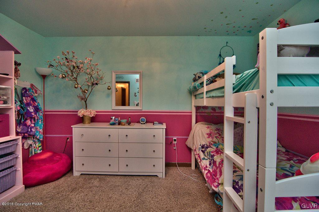 251 Devils Hole Road Cresco, PA 18326 - Photo 30 of 35 a bedroom with a bed and a white dresser