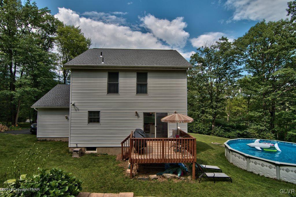 251 Devils Hole Road Cresco, PA 18326 - Photo 3 of 35 a front view of a house with a garden