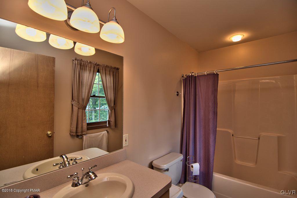 251 Devils Hole Road Cresco, PA 18326 - Photo 33 of 35 a bathroom with a sink mirror vanity and toilet