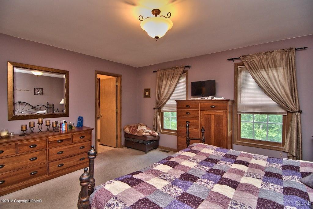 251 Devils Hole Road Cresco, PA 18326 - Photo 34 of 35 a bedroom with a bed and a flat screen tv