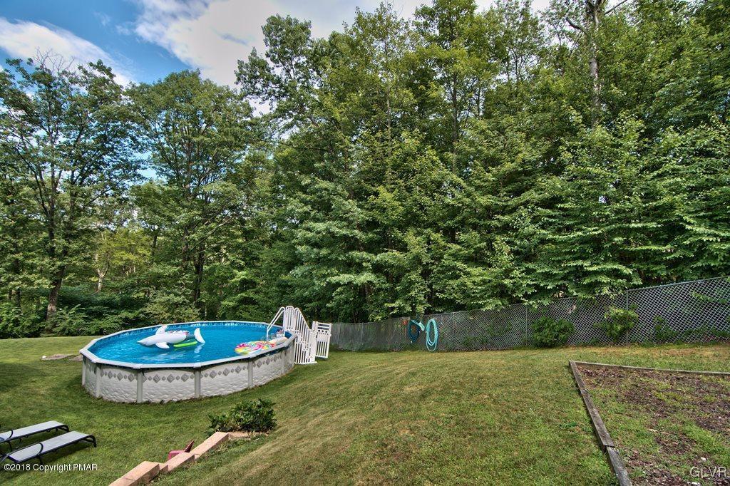 251 Devils Hole Road Cresco, PA 18326 - Photo 6 of 35 a view of a backyard with plants and trees