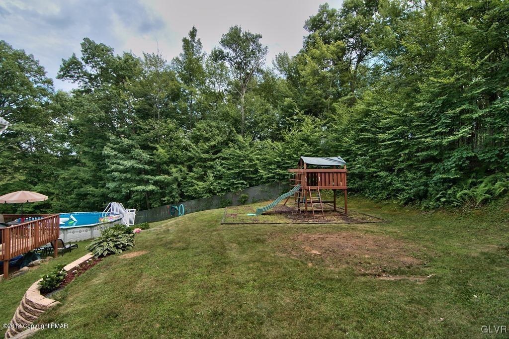 251 Devils Hole Road Cresco, PA 18326 - Photo 8 of 35 a backyard of a house with table and chairs