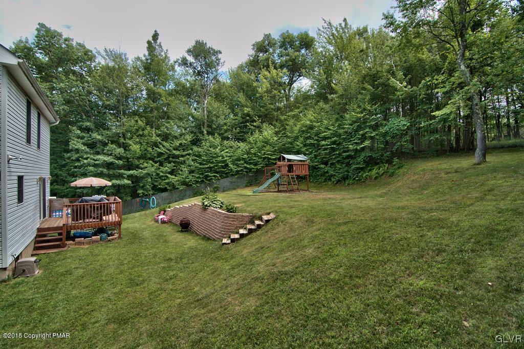 251 Devils Hole Road Cresco, PA 18326 - Photo 9 of 35 a backyard of a house with table and chairs