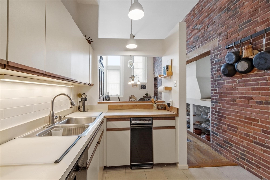 66 Haskell Street, Unit 1N Beverly, MA 01915 - Photo 15 of 27 a kitchen with a stove a sink and a refrigerator