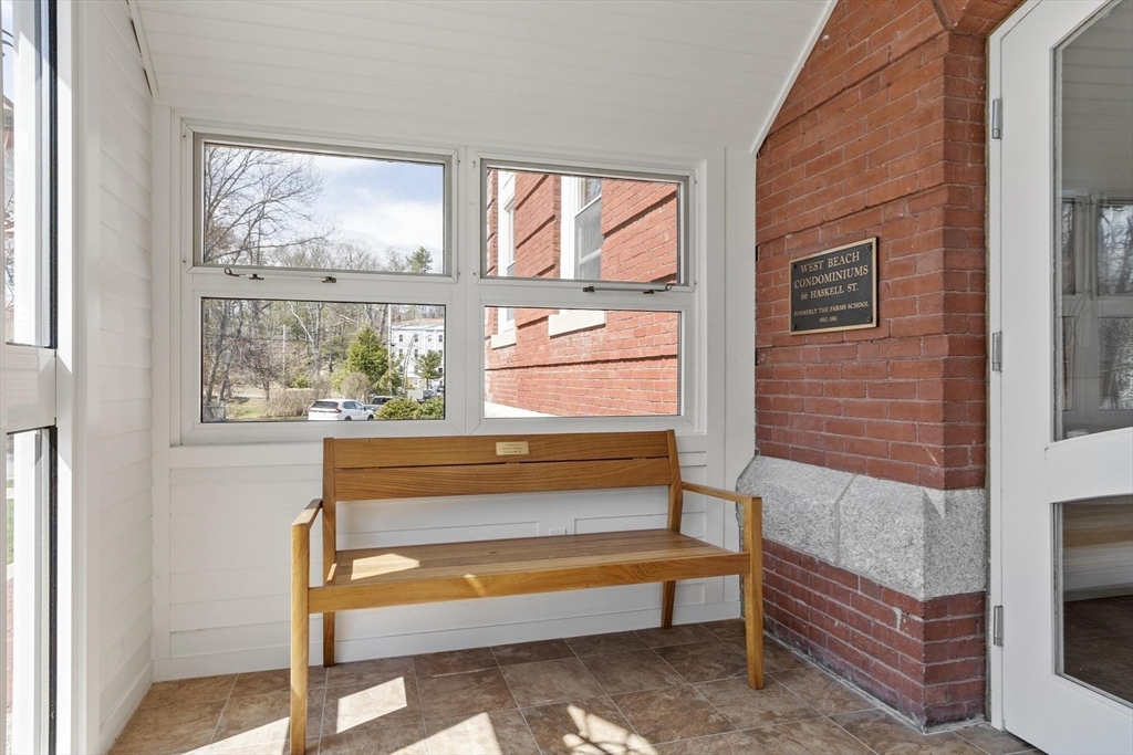 66 Haskell Street, Unit 1N Beverly, MA 01915 - Photo 3 of 27 a view of bench in front of building