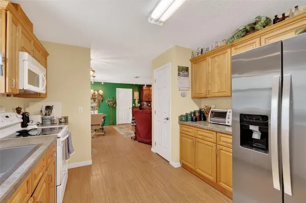 a kitchen with a refrigerator and a stove top oven