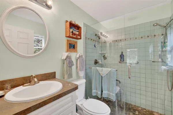 a bathroom with a toilet a sink and mirror